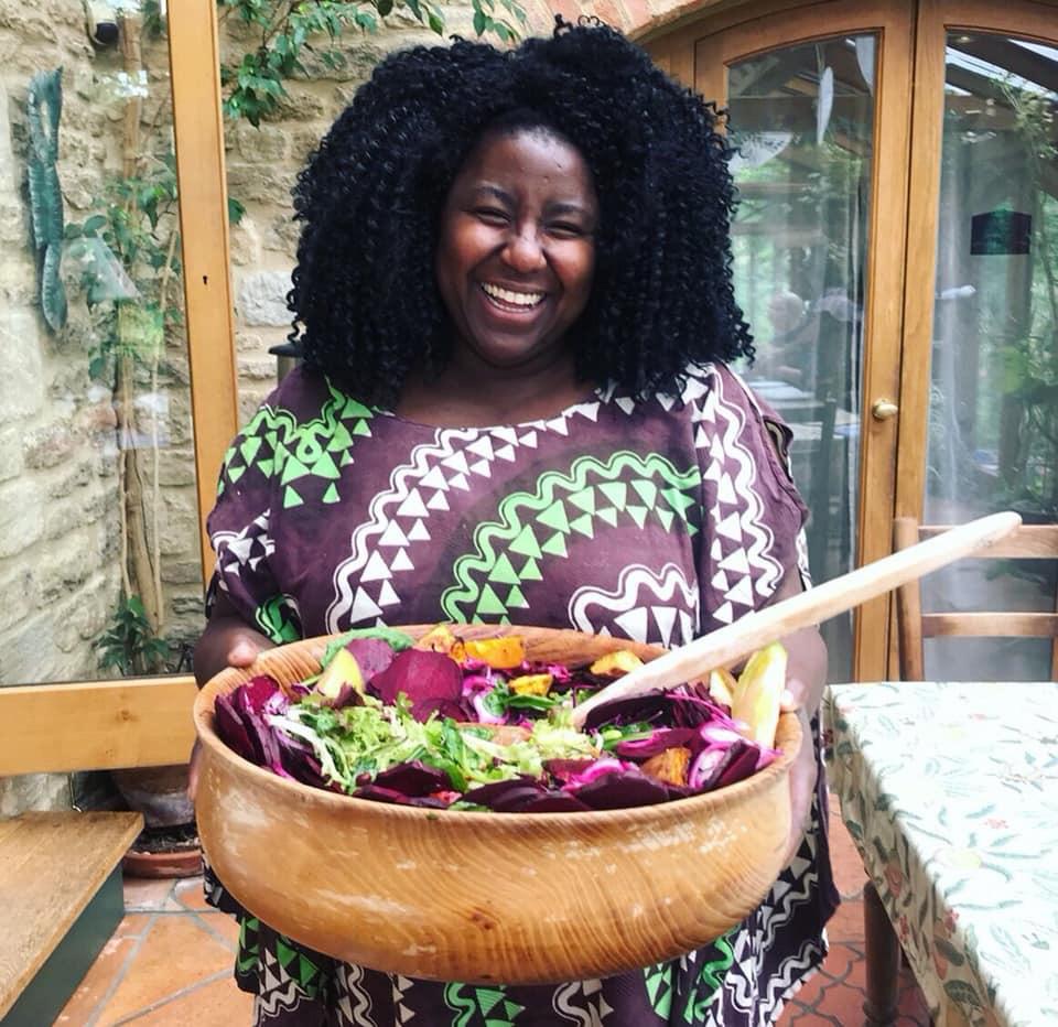 Retreat host presenting a colourful shared meal