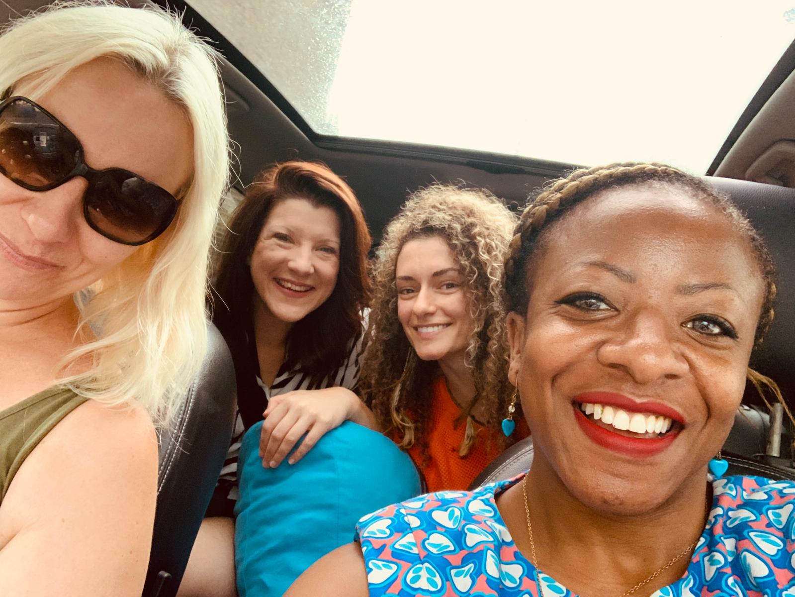Friends smiling together during a retreat journey